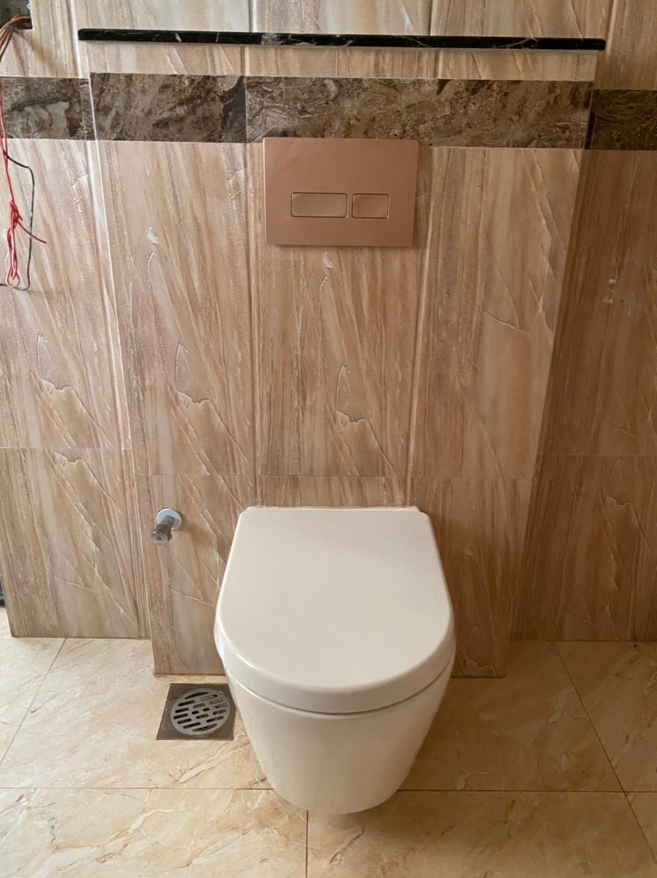 Bathroom walls and sanitary area finished with aligned tiles