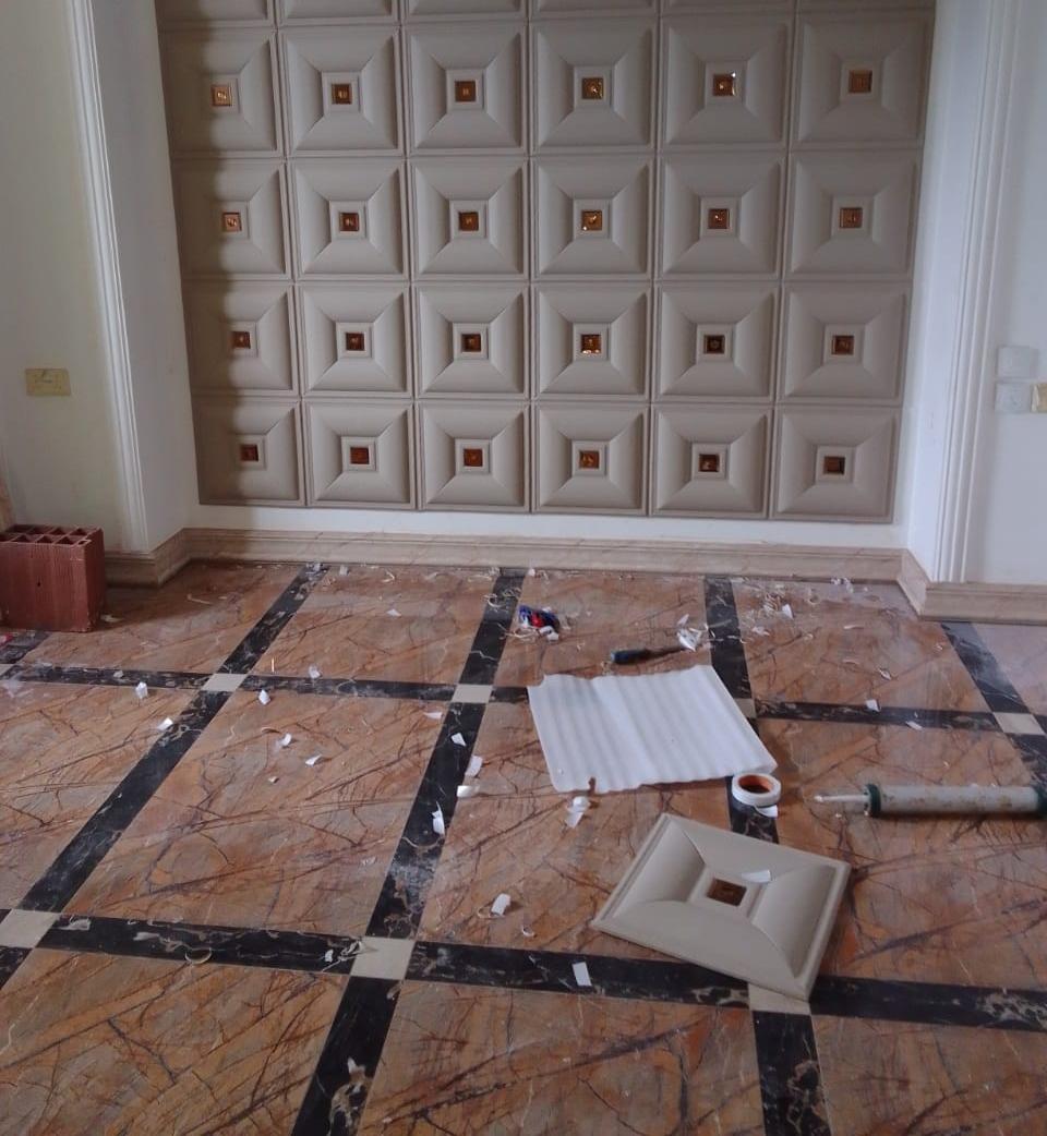 Floor tile installation and alignment in progress